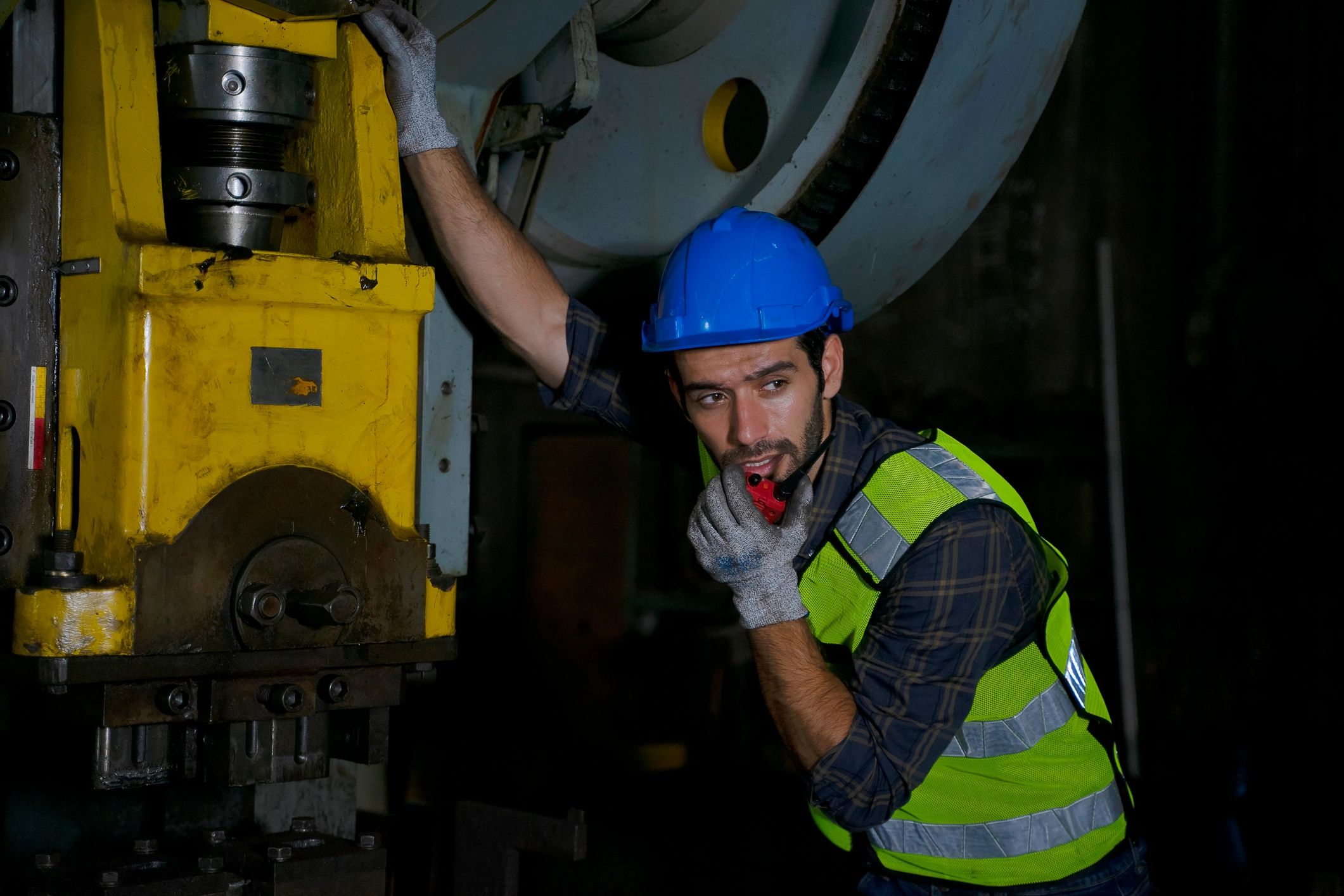 Engineer working on industrial turbine components in a factory setting